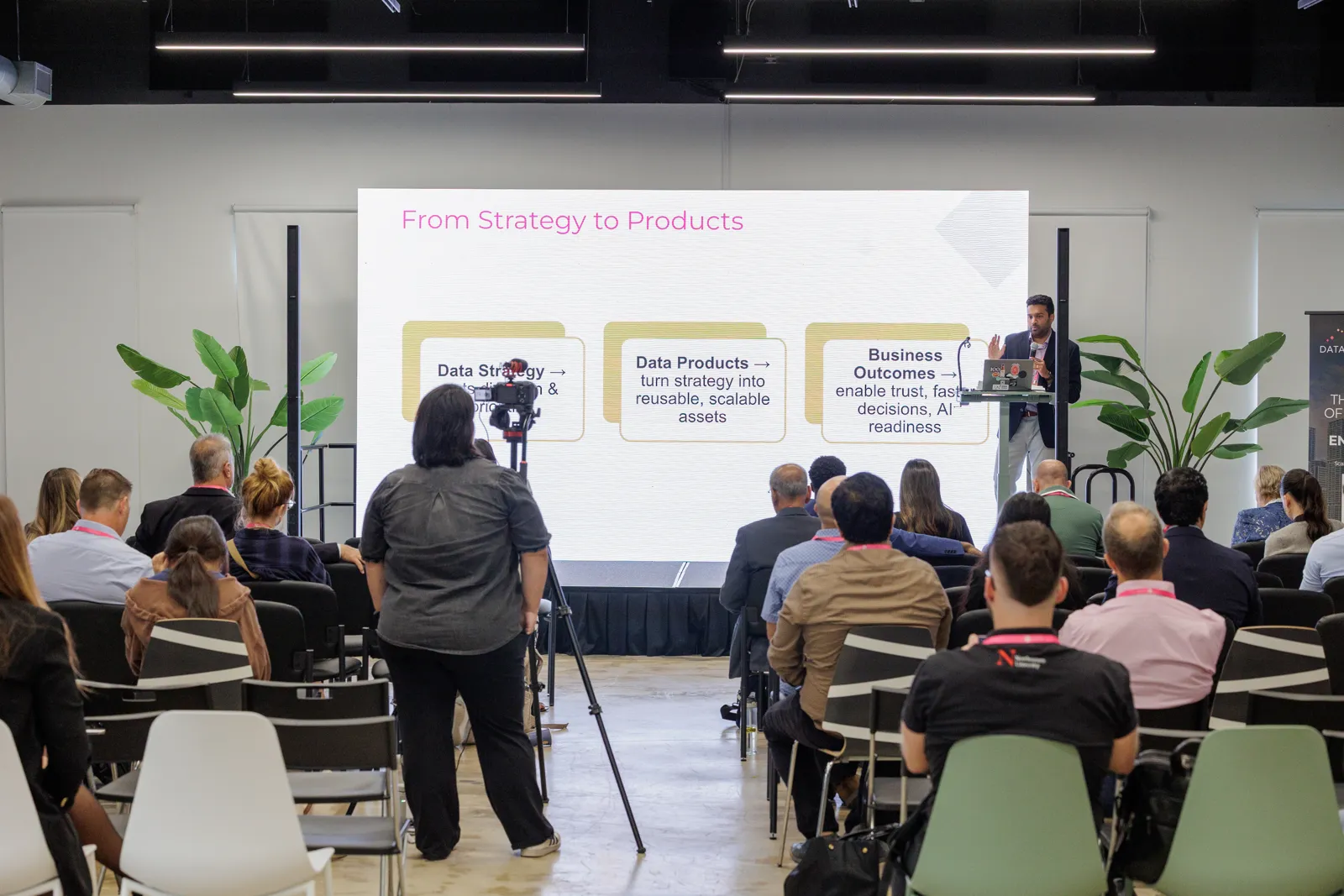 Speaker presenting a data product strategy session to an AI Loves Data conference audience.
